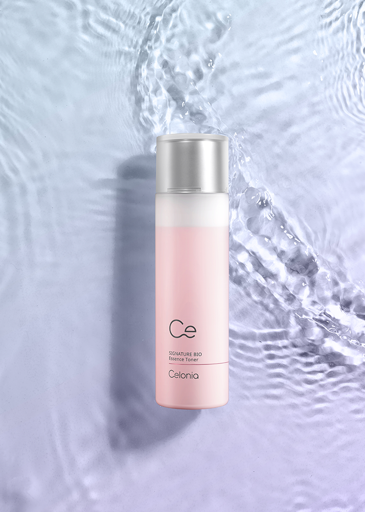 Skincare bottle with silver cap on a textured water background