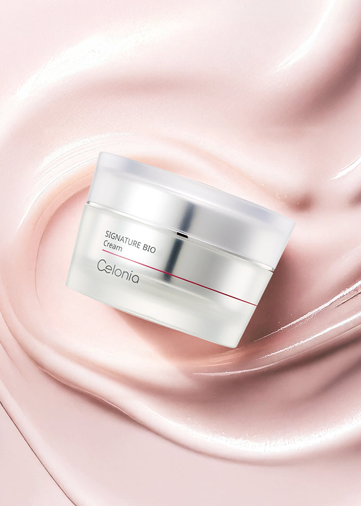 Cosmetic cream jar labeled 'Signature Bio Cream' by Celonia on a pink swirling background