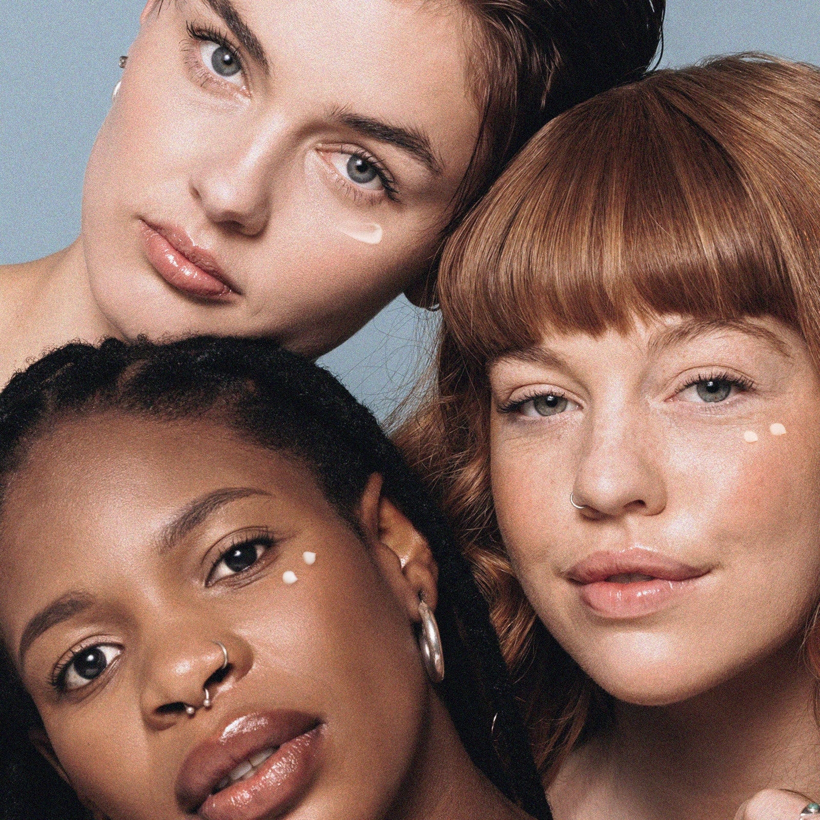 Three women with a light blue background