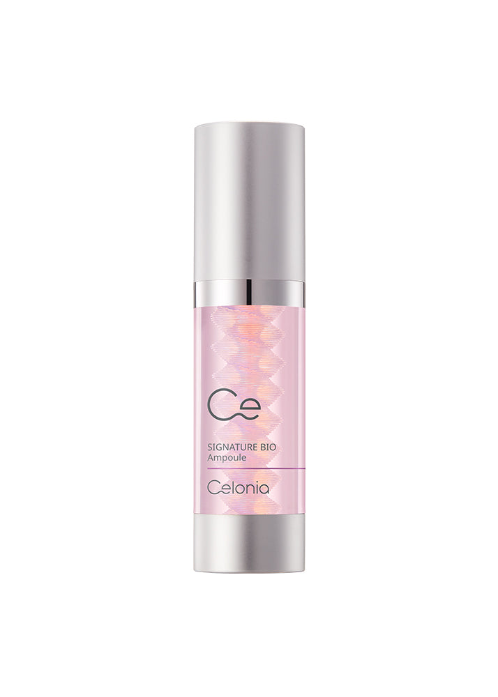 Skincare serum bottle with silver cap and pink label on a white background