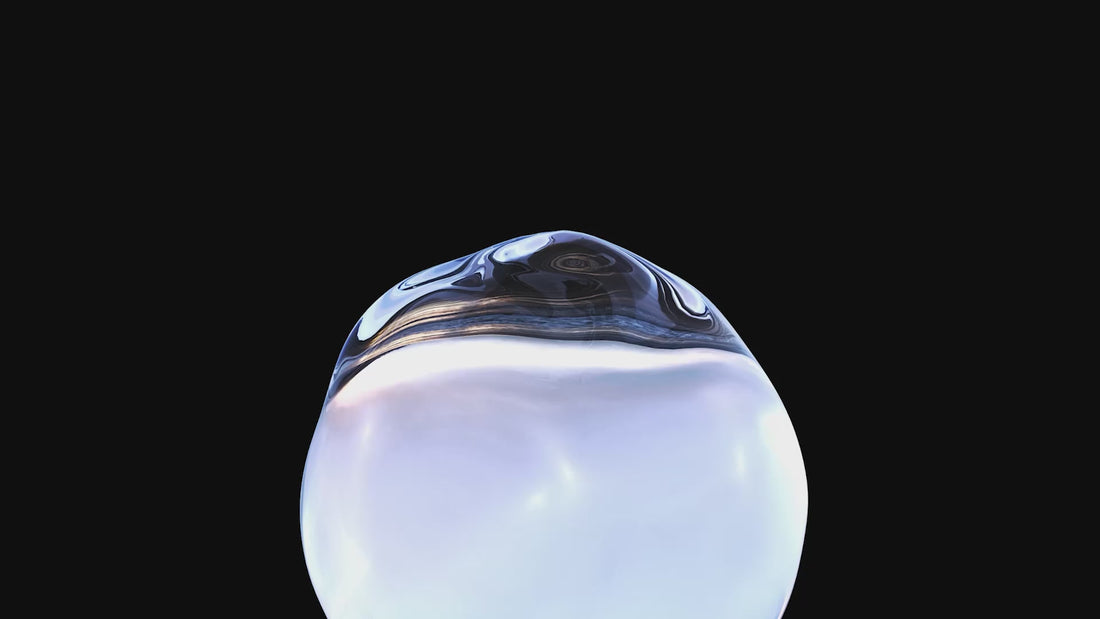 Close-up of a reflective metallic object on a black background