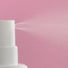 Celonia Signature Bio Energy Essence mist spray on a soft pink background, showing fine hydrating mist application